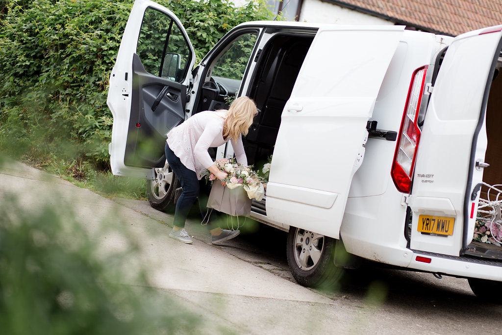 wedding florist loading flowers into van