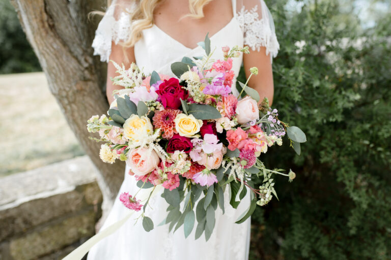 Pale pink, peach and crimson wedding bouquet