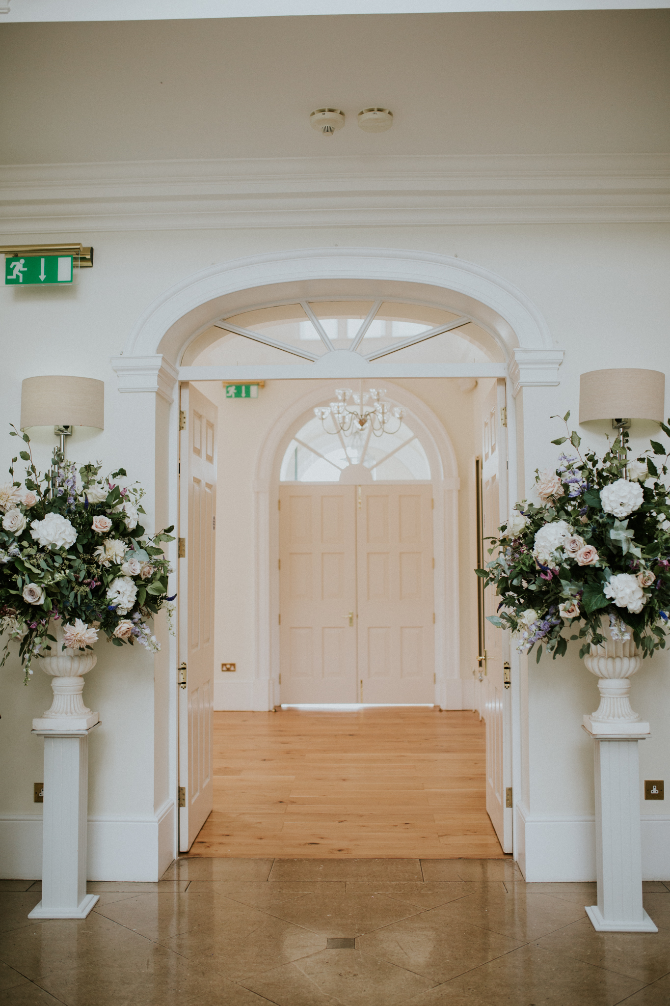 Large white urn arrangements wedding flowers