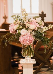 pink urn arrangement church wedding flowers
