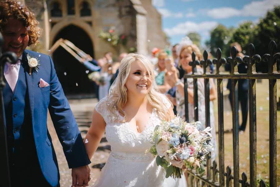 Smiling bride with pastel coloured bouquet