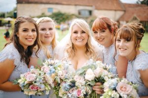 Bride with her bridesmaids pastel wedding bouquets Priston Mill Tythe Barn