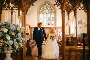 bride and groom pink and blue church wedding flowers