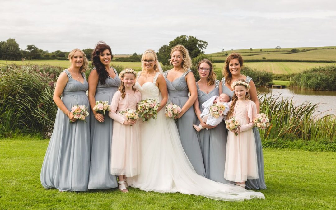 bride and bridesmaids with flower girls