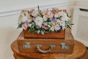 wedding flowers arrangement in vinatge suitcase