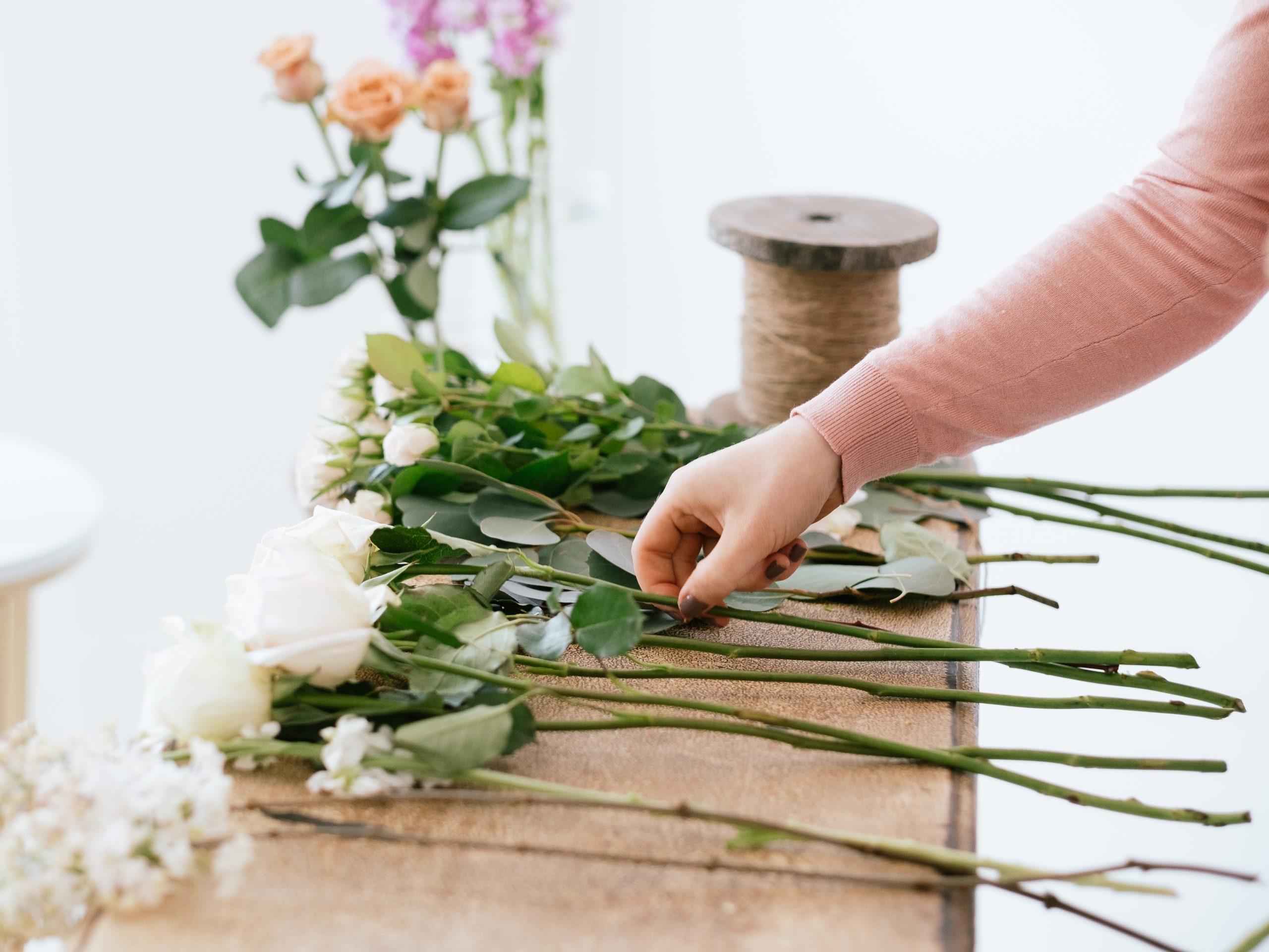 Stems laid out on bench for florist to arrange