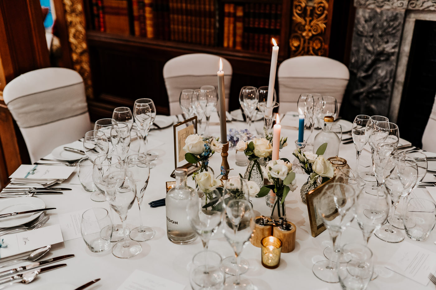 guest tables decorated with cut glass jars, flowers and candles 