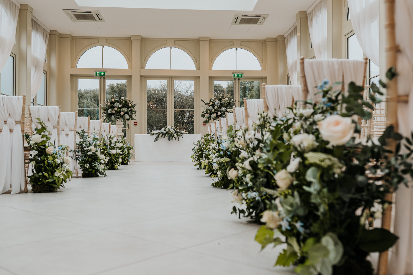 Vertical meadow arrangements lining ceremony aisle