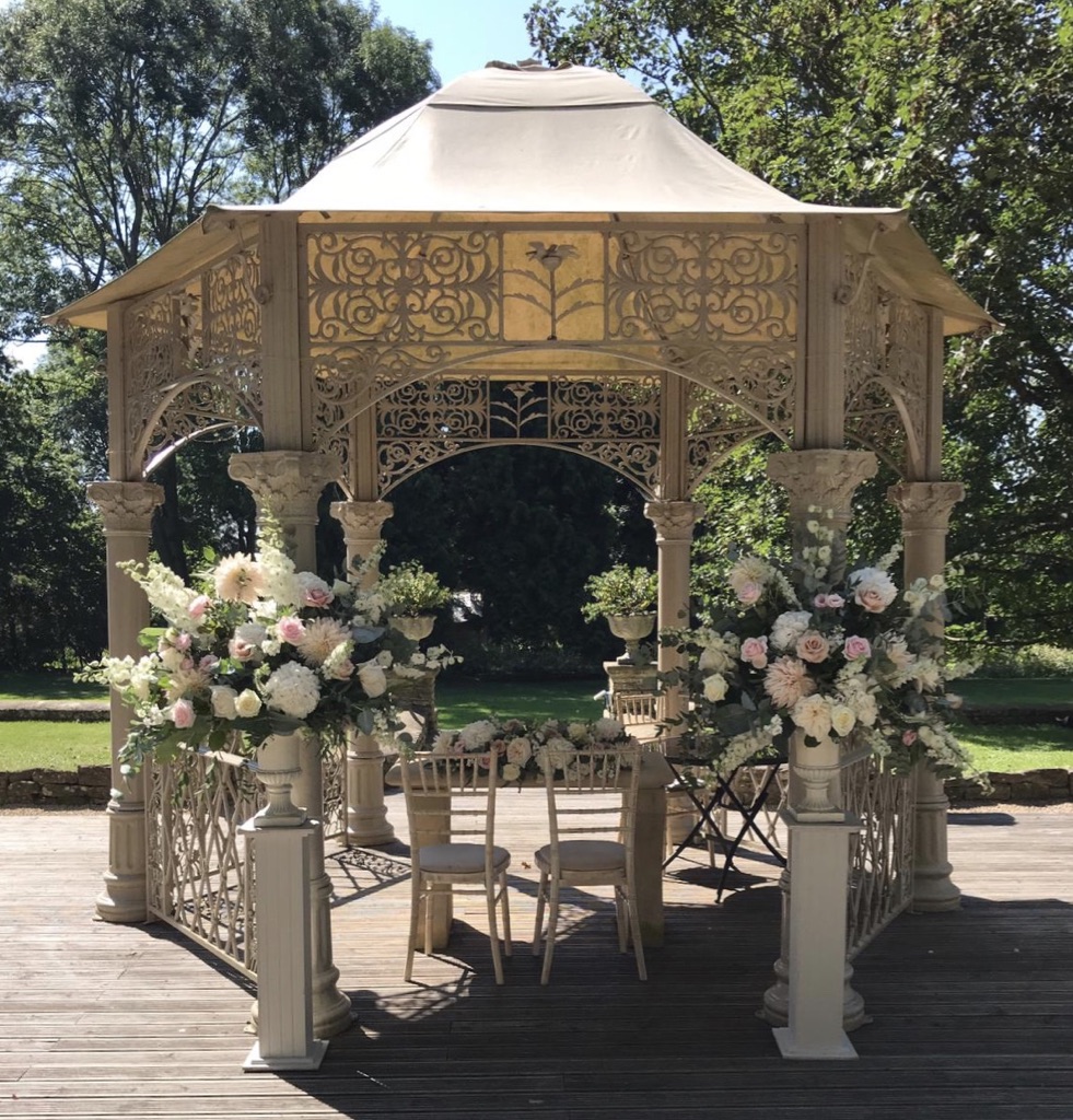 Wedding flowers at Eastington park outdoor ceremony pagoda