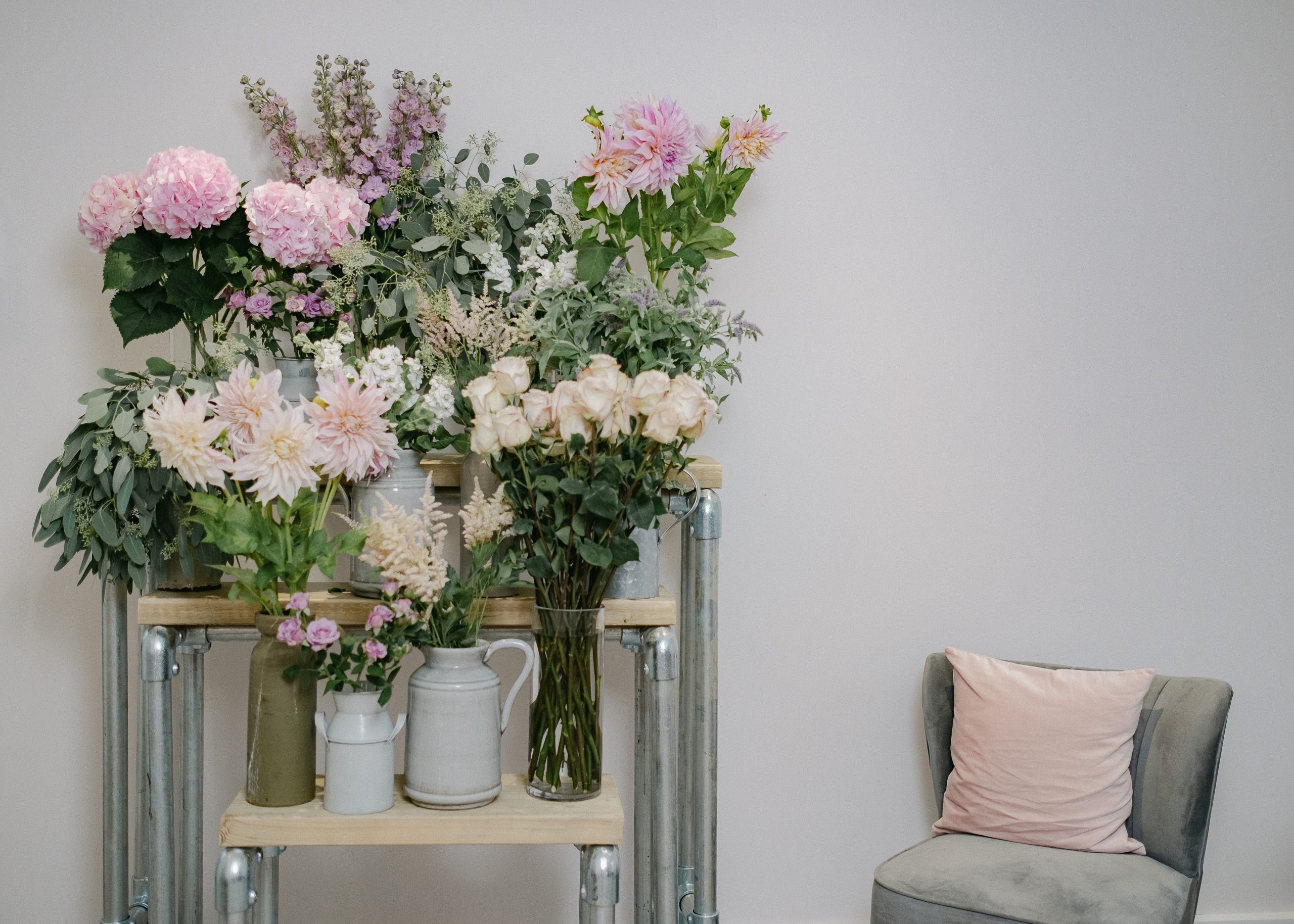 display of flowers beside chair